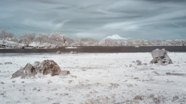 Mount Shasta and Hog Lake at Sacramento Riverbend Area near Red Bluff in 720nm false color infrared, volcanic boulders foreground