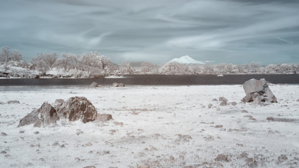 Mount Shasta and Hog Lake at Sacramento Riverbend Area near Red Bluff in 720nm false color infrared, volcanic boulders foreground