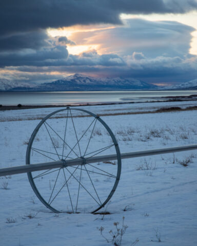 Wheel Line and Lenticular Cloud – Honey Lake Valley – Lassen County California Single irrigation wheel line in snow-covered Honey Lake Valley hay field with lenticular cloud and storm sky, Lassen County, California