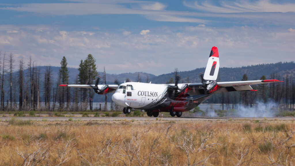 Coulson C-130 airtanker touching down at Rogers Field, Chester, CA, alongside Lake Almanor to reload for the Biscar Fire.